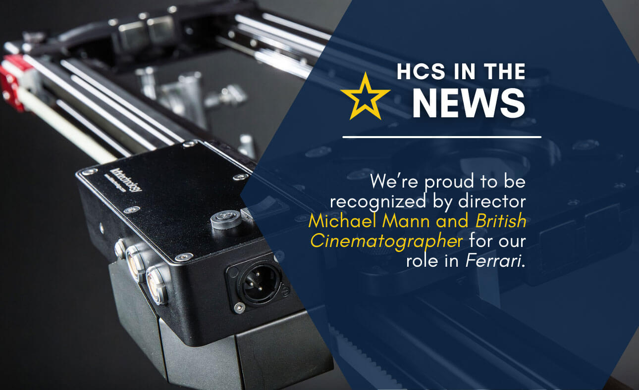 HCS news graphic with industrial machine background